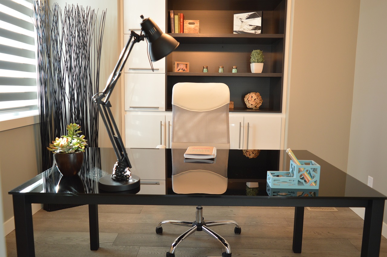 Modern office interior in Karnataka with cabin, table, chair, lamp, and bookshelf