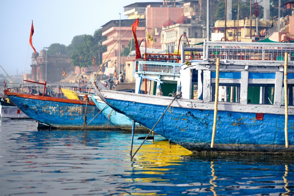 "Virtual office for GST registration in Uttar Pradesh, serene river with boats and spiritual ambiance."