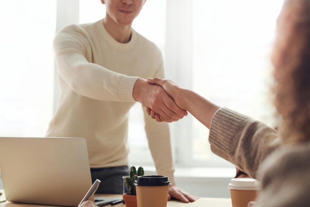 Business handshake in a modern office, representing a virtual office for GST registration